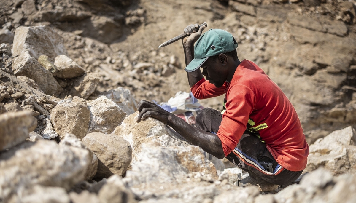 A miner uses a chisel to split stones containing lithium collected at a mining site in Gidan Kwano, in Nasarawa state in Nigeria, on 23 January 2025.