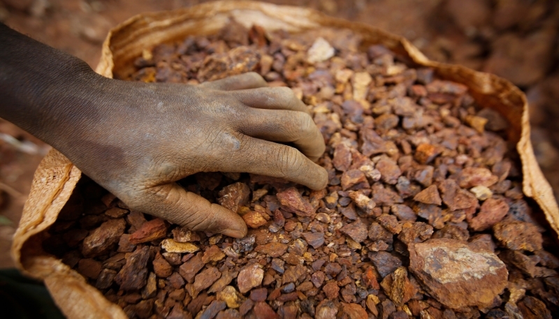 A miner shows a sack full of gold-containing ores that he and others extracted in Macalder, Migori county, western Kenya, 29 February 2016.
