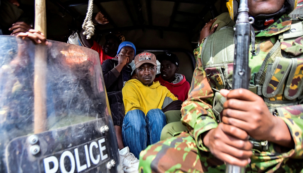 Riot police officers detain demonstrators during anti-government protests in the Rift Valley town of Nakuru, Kenya, 7 July 2025.