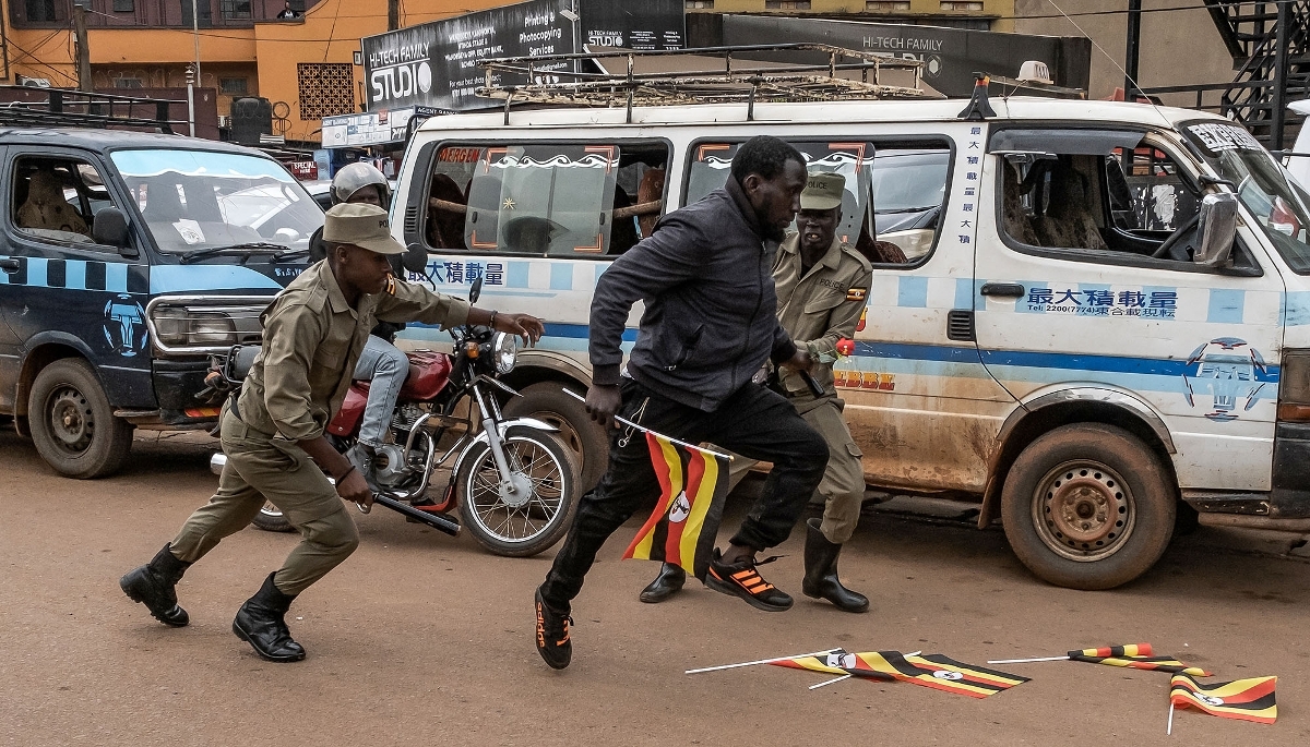 Police chase an opposition supporter during a demonstration in Kampala on 2 February 2026.