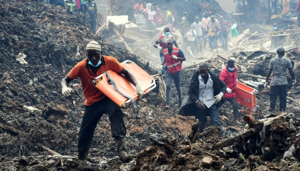 Volunteers search for the bodies of residents killed by a landslide in the Kiteezi garbage dumping site, outside Kampala, 10 August 2024.