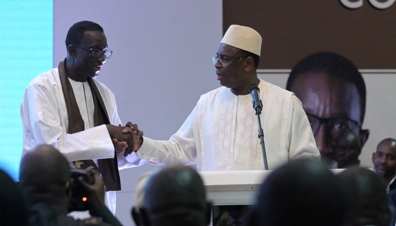 Senegalese President Macky Sall (C) with Prime Minister Amadou Ba in Dakar on 21 December 2023. Seyllou/AFP