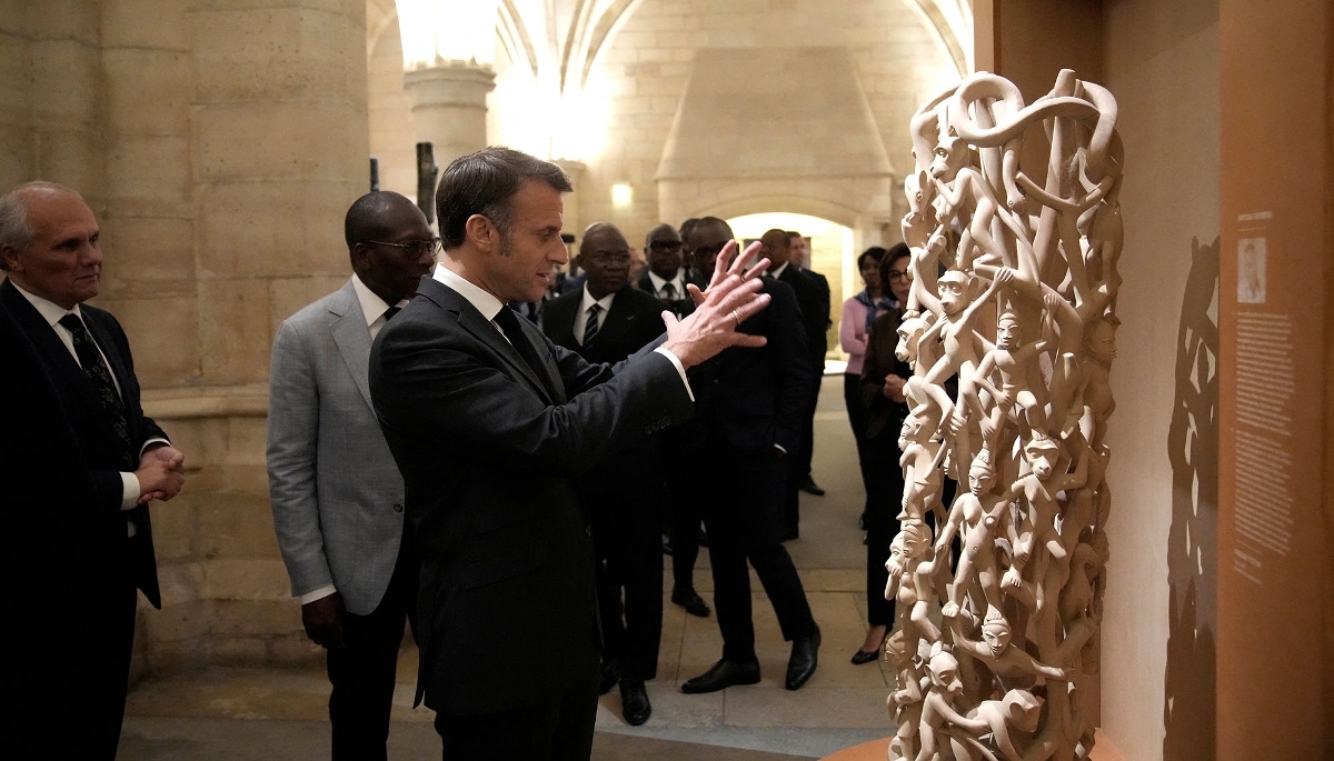 Emmanuel Macron (centre) and Patrice Talon (second from left) open an exhibition of contemporary Beninese art at the Conciergerie in Paris on 3 October 2024.
