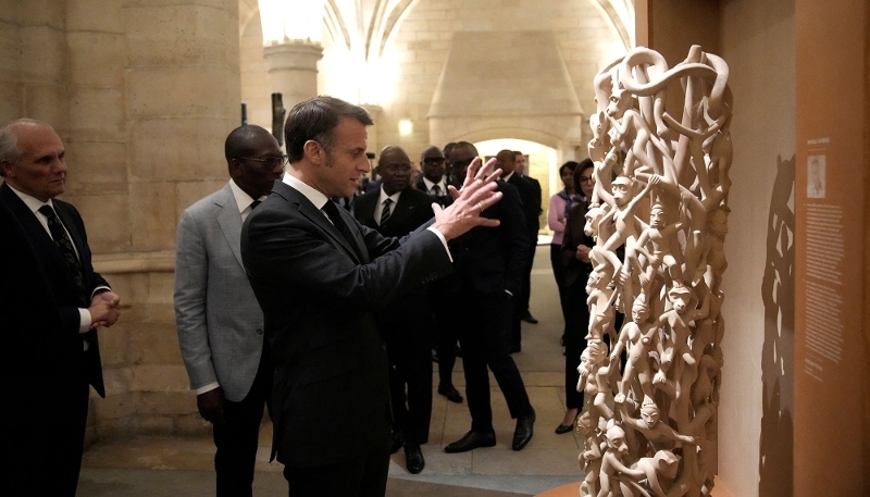 Emmanuel Macron (centre) and Patrice Talon (second from left) open an exhibition of contemporary Beninese art at the Conciergerie in Paris on 3 October 2024.