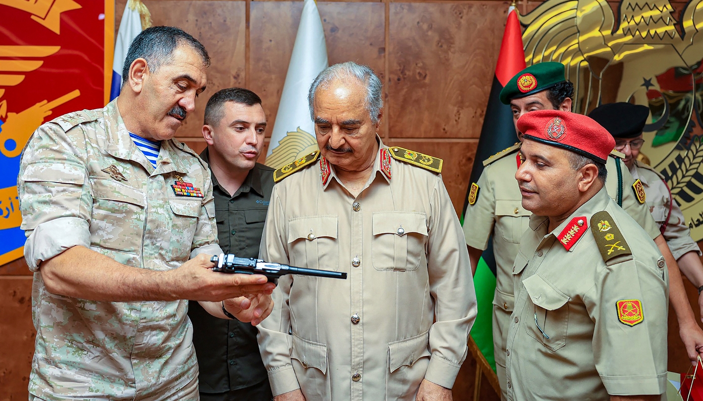 Russia's Deputy Defence Minister Yunus-Bek Yevkurov offering a pistol as a gift to Libyan military strongman Khalifa Haftar, during his visit to Benghazi on 24 August 2023.