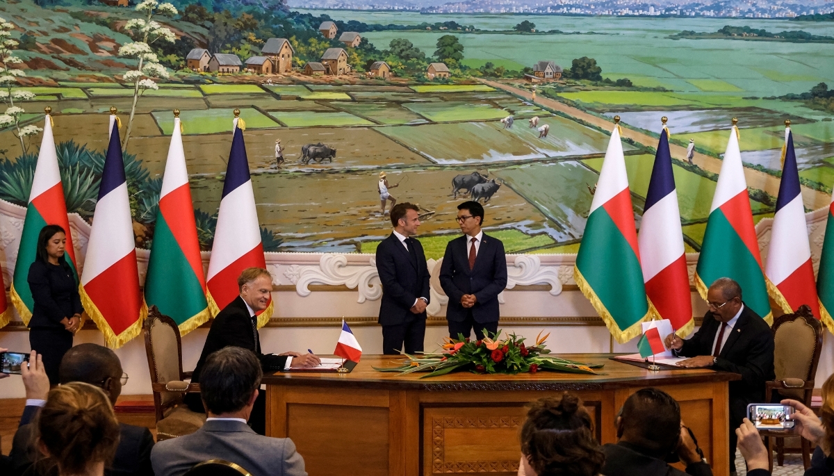 CEO of Volobe General Hydroelectricity Company (CGHV) Remy Huber and Madagascar's Minister of Energy and Hydrocarbons Olivier Jean-Baptiste, in front of French and Malagasy presidents Emmanuel Macron and Andry Rajoelina, respectively, in Antananarivo on 23 April 2025.