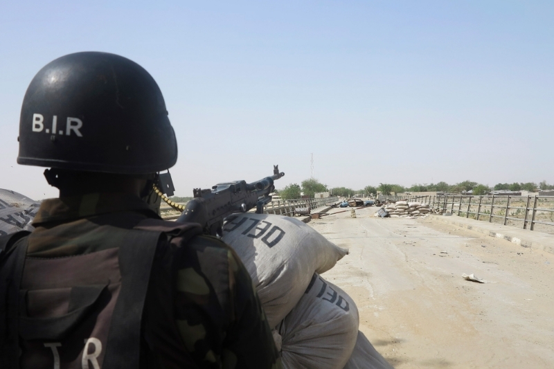 A Cameroon special forces soldier stands guard on the Elbeid bridge in Fotokol, on 17 February 2015.