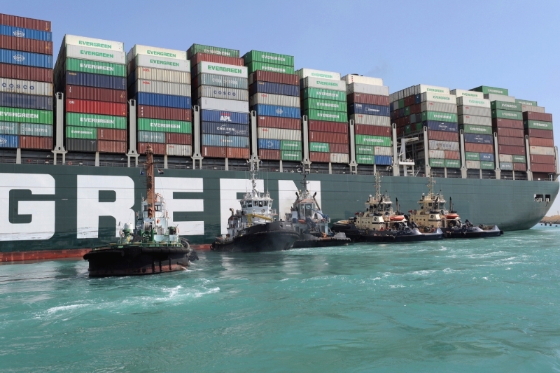 Rescue vessels work at the site of the stuck container ship Ever Given on the Suez Canal, 28 March 2021.