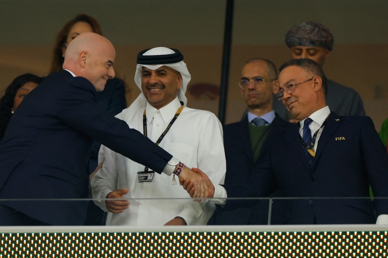 FIFA President Gianni Infantino (L) speaks with Qatar's Prime Minister Khalid bin Khalifa bin Abdulaziz Al Thani (C) and President of Morocco's Royal Football Federation (FRMF) Fouzi Lekjaa (R) prior to the Qatar 2022 World Cup quarter-final football match between Morocco and Portugal at the Al-Thumama Stadium in Doha on 10 December 2022.