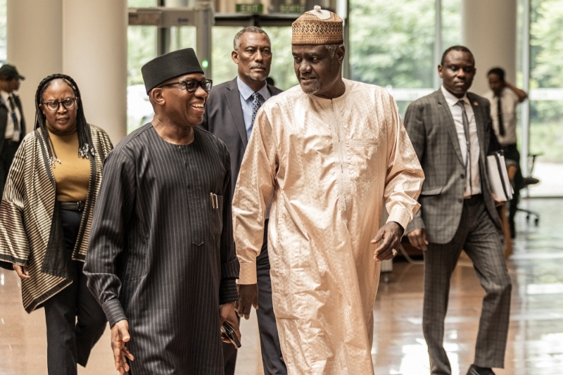 Bankole Adeoye, African Union (AU) Commissioner for Political Affairs, Peace and Security, and Moussa Faki Mahamat, Chairperson of the African Union Commission (AUC), talk between themselves as they arrive at the AU headquarters for a meeting of the Extended Mechanism on the Sudan Crisis in Addis Ababa on 2 May 2023.